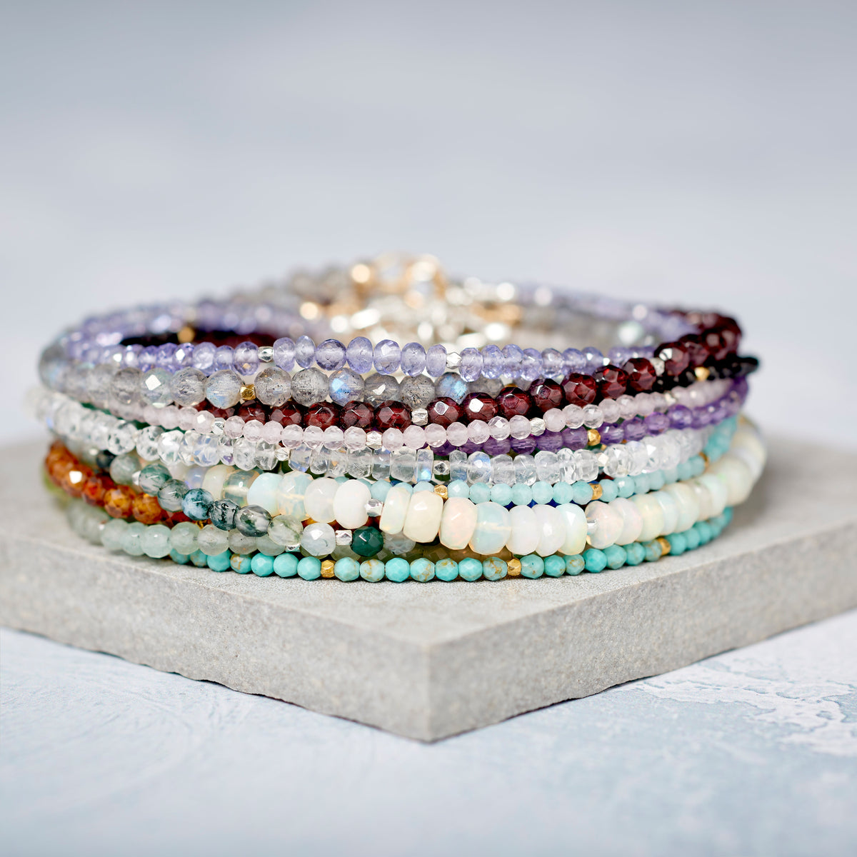 Handmade dainty gemstone bracelets in natural colours, arranged for stacking